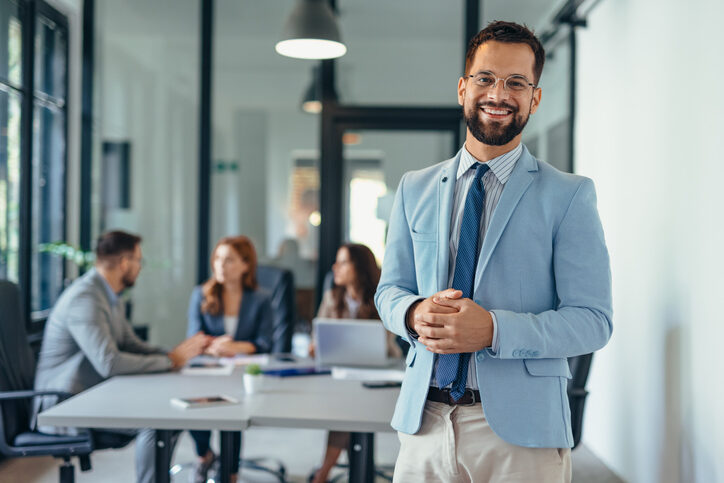 Confident business consultant in office supporting sales consulting and strategy solutions.